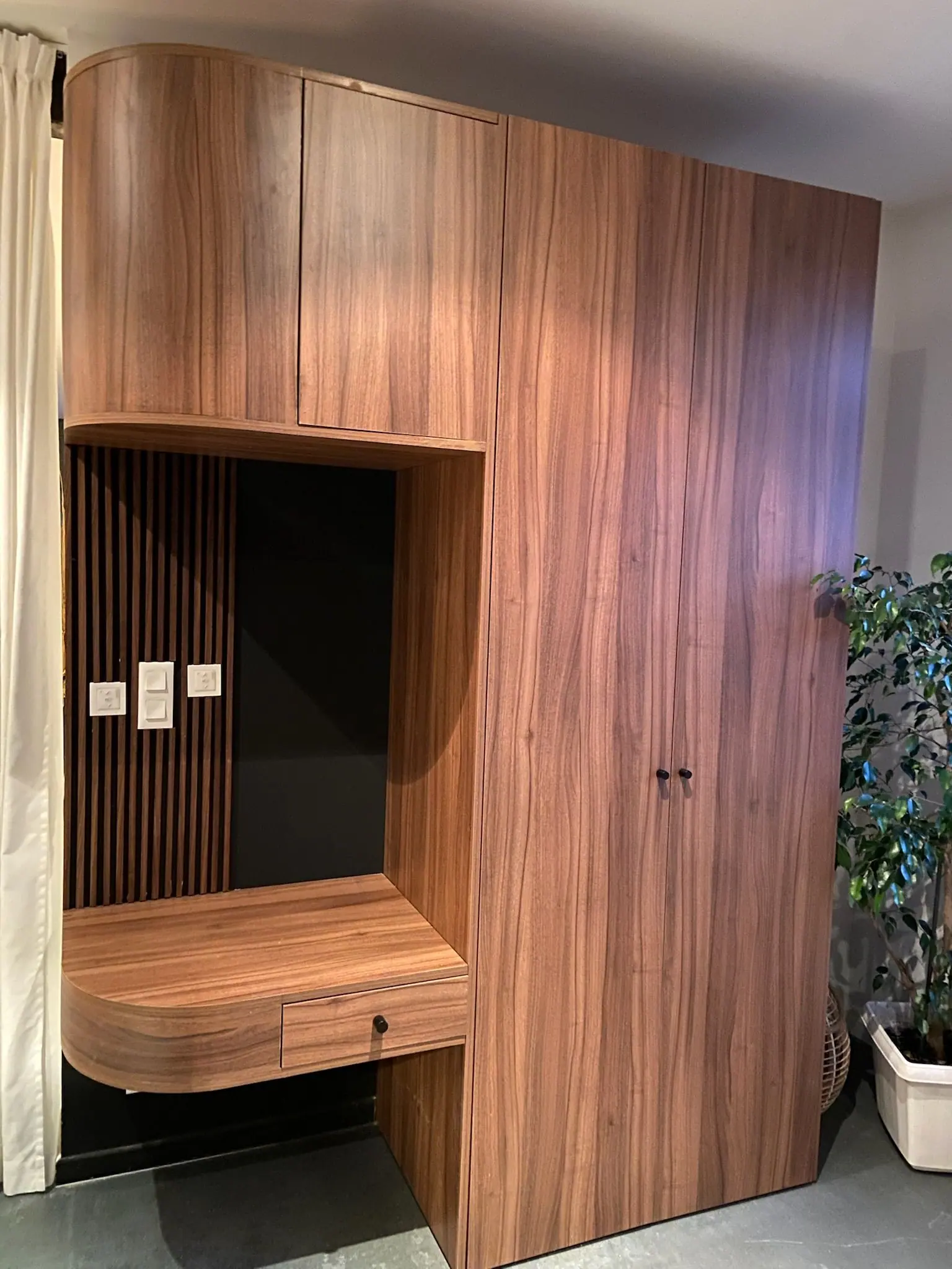 Grand meuble en bois foncé avec niche, tablette suspendue et rangements fermés